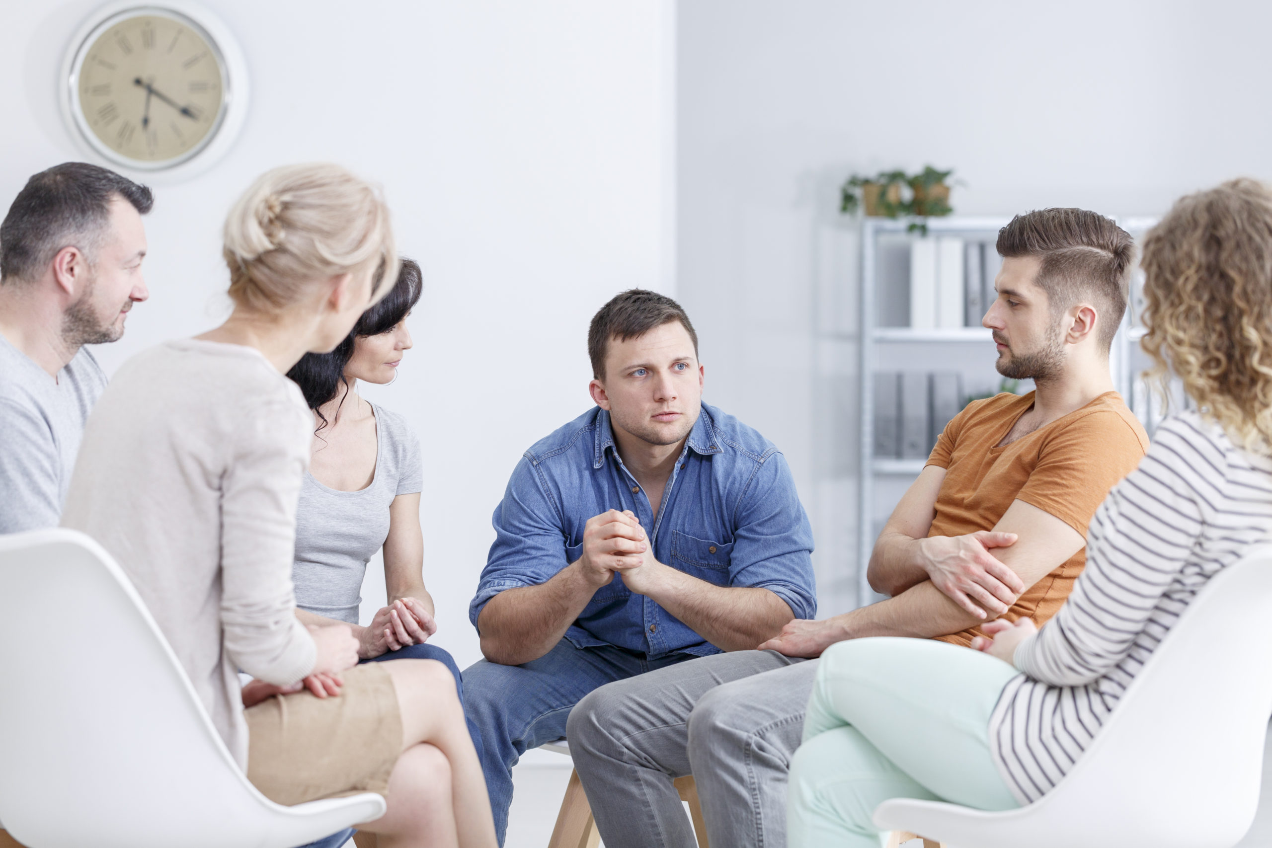 Focused man talking to people